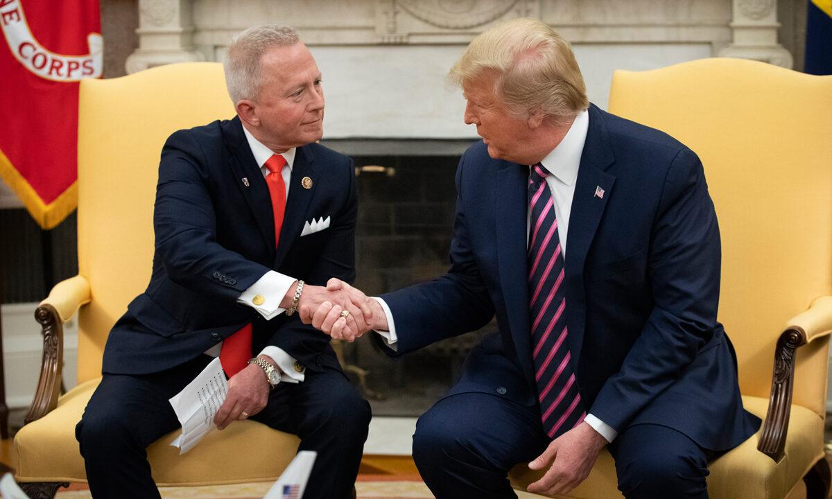 (L-R) Rep. Jeff Van Drew of New Jersey, who has announced he is switching from the Democratic to Republican Party, shakes hands with President Donald Trump in the Oval Office of the White House on Dec. 19, 2019 (Drew Angerer/Getty Images)
