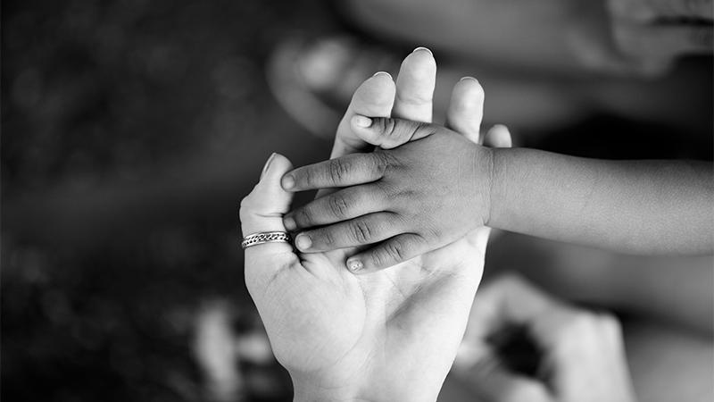 Photo of Police Officer Cuddling Baby of Overdosed Parents Goes Viral