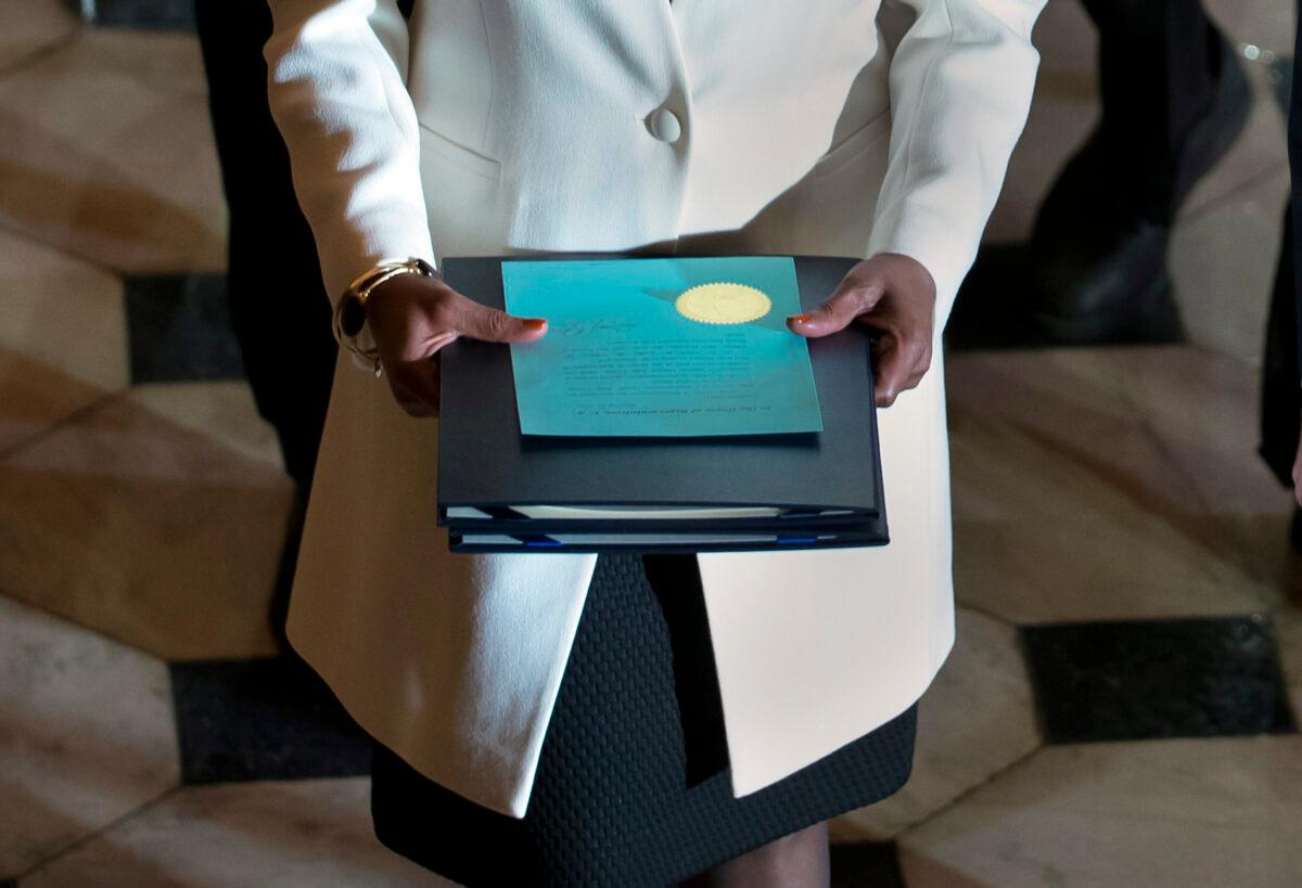 Clerk of the House Cheryl Johnson carries the articles of impeachment against President Donald Trump to the Senate, on Capitol Hill in Washington on Jan. 15, 2020. (J. Scott Applewhite/AP Photo)
