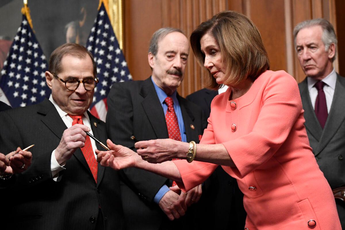House Speaker Nancy Pelosi (D-Calif.), second from right, gives pens to (L-R) House Judiciary Chairman Rep. Jerrold Nadler (D-N.Y.), House Foreign Affairs Committee Chairman Eliot Engel (D-N.Y.), and House Ways and Means Committee Chairman Richard Neal (D-Mass.), after she signed the resolution to transmit the two articles of impeachment against President Donald Trump to the Senate for trial on Capitol Hill in Washington on Jan. 15, 2020. (Susan Walsh/AP Photo)