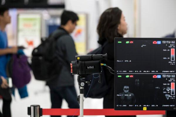A health worker monitors a thermal scanner as passengers arrive at Narita airport in Narita, Japan, on Jan. 17, 2020. (Tomohiro Ohsumi/Getty Images)