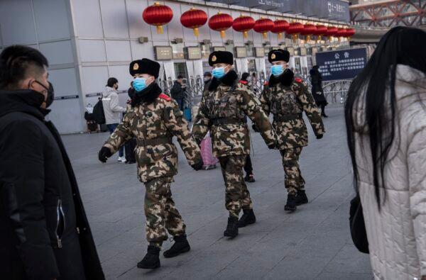 Chinese police officers wear protective masks as they patrol before the Chinese New Year at a Beijing railway station in Beijing, China on Jan. 23, 2020. (Kevin Frayer/Getty Images)