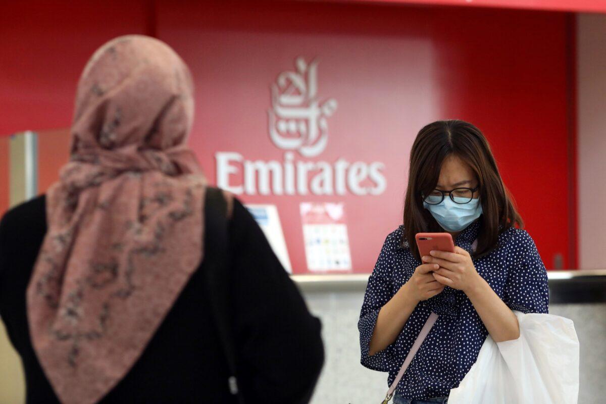 A traveler wears a mask at the Dubai International Airport, after the UAE's Ministry of Health and Community Prevention confirmed the country's first case of coronavirus, in Dubai, United Arab Emirates on Jan. 29, 2020. (Christopher Pike/Reuters)