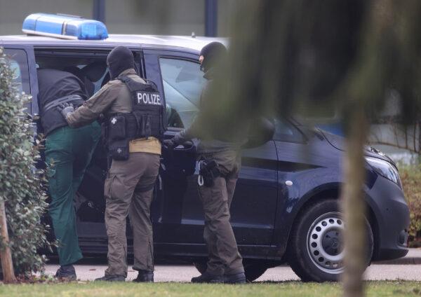 One of 12 men suspected of involvement in right-wing terrorism is escorted by police as he arrives for his hearing at Germany's general prosecutor in Karlsruhe, Germany, on Feb. 15, 2020. (Kai Pfaffenbach/Reuters)