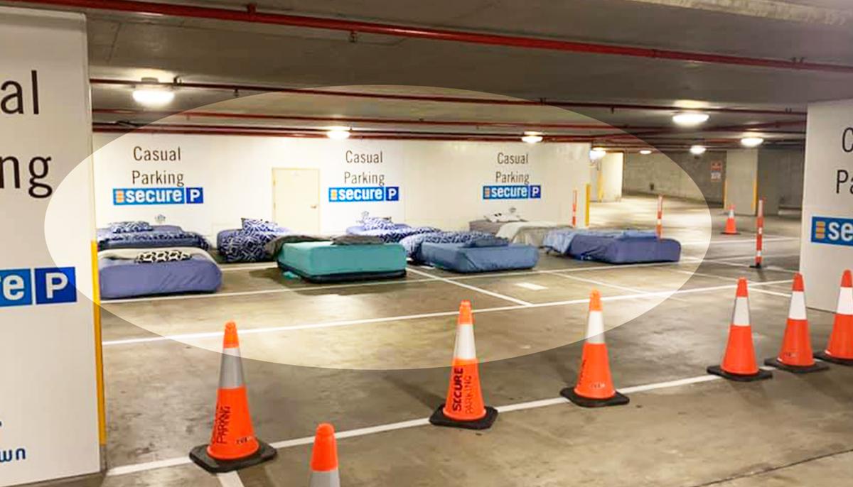 Homeless Sleep on Real Beds in Empty Parking Garage Thanks to Safe Overnight Shelter Program