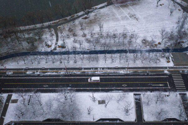 An ambulance on a street as snow falls in Wuhan, China, on Feb. 15, 2020. (Getty Images)