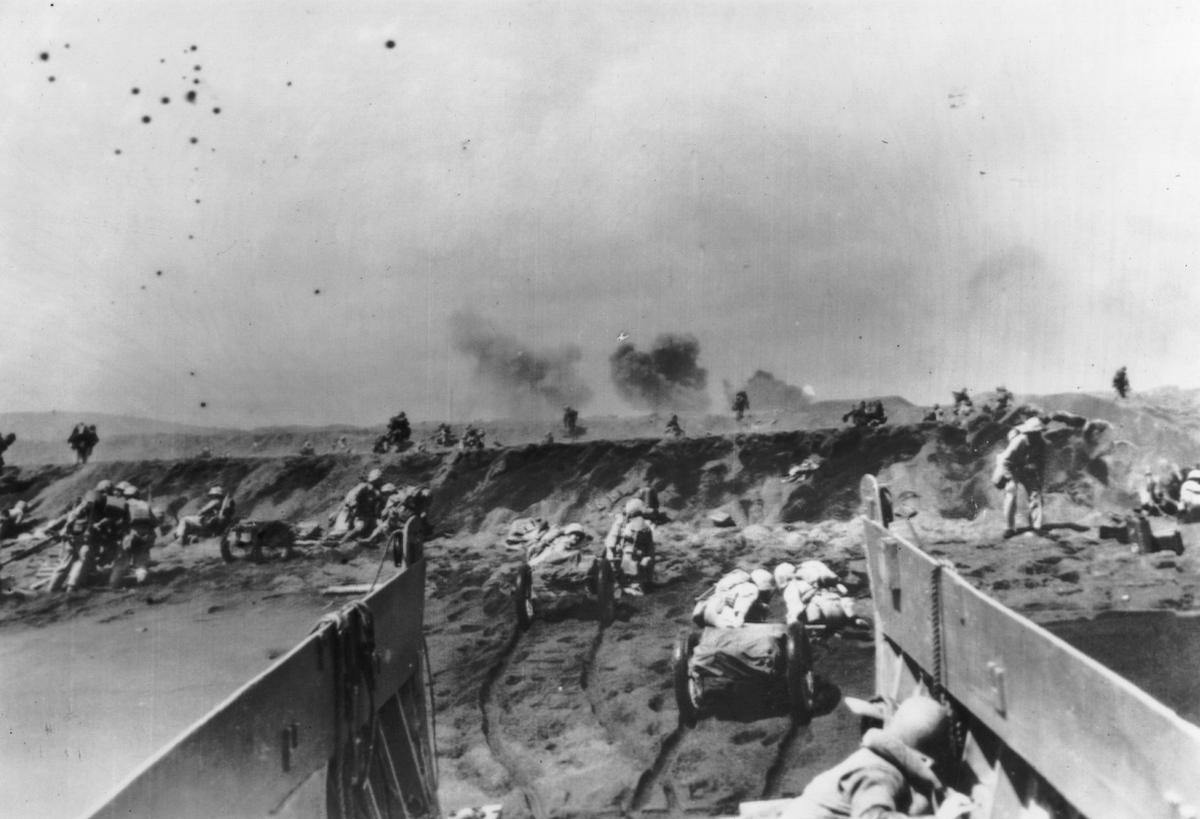 19th February 1945: American marines storming the beaches of Iwo Jima, dragging mobile artillery with them. (Keystone/Getty Images)