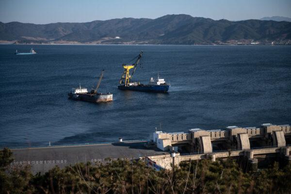 Ships are moored next to the West Sea Barrage, a system of dams, lock chambers, and sluices that close off the Taedong River from the Yellow Sea, in Nampo, North Korea, on Feb. 7, 2019. (Carl Court/Getty Images)