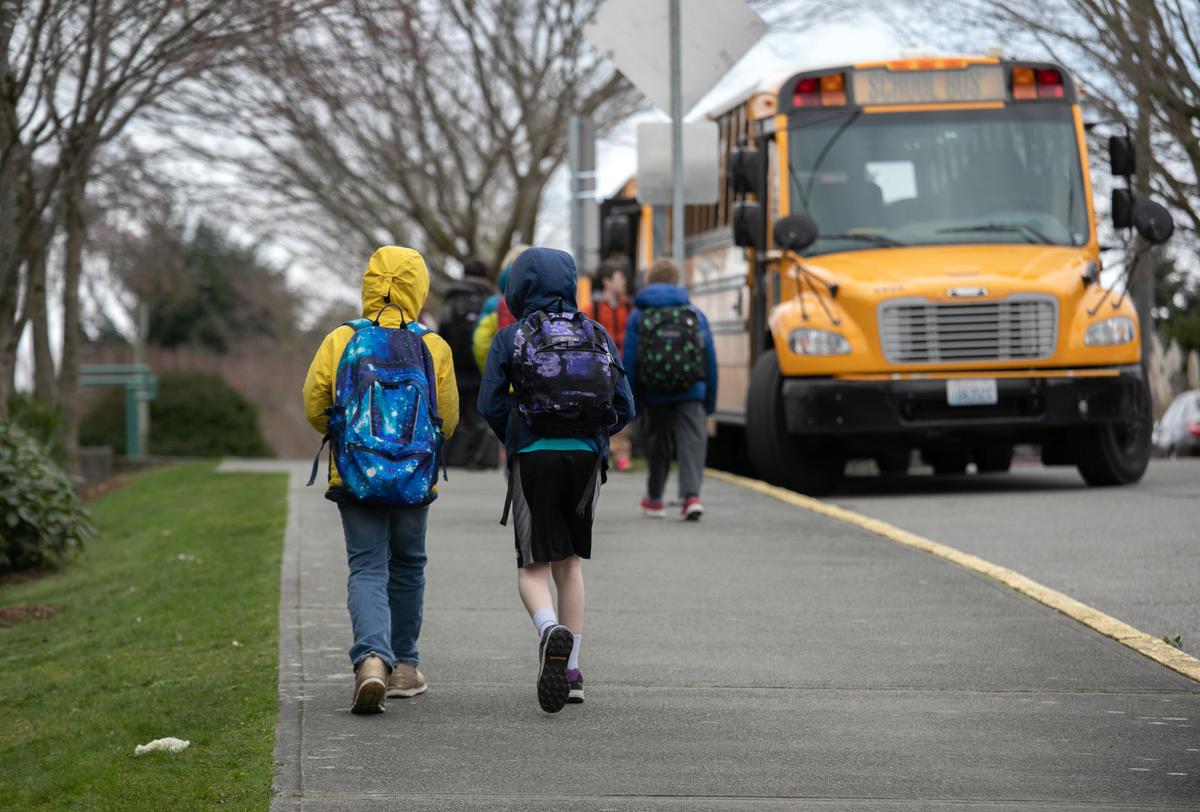 Students leave the Thurgood Marshal Elementary school after the Seattle Public School system was abruptly closed due to CCP virus fears in Seattle, Wash., on March 11, 2020. (John Moore/Getty Images)