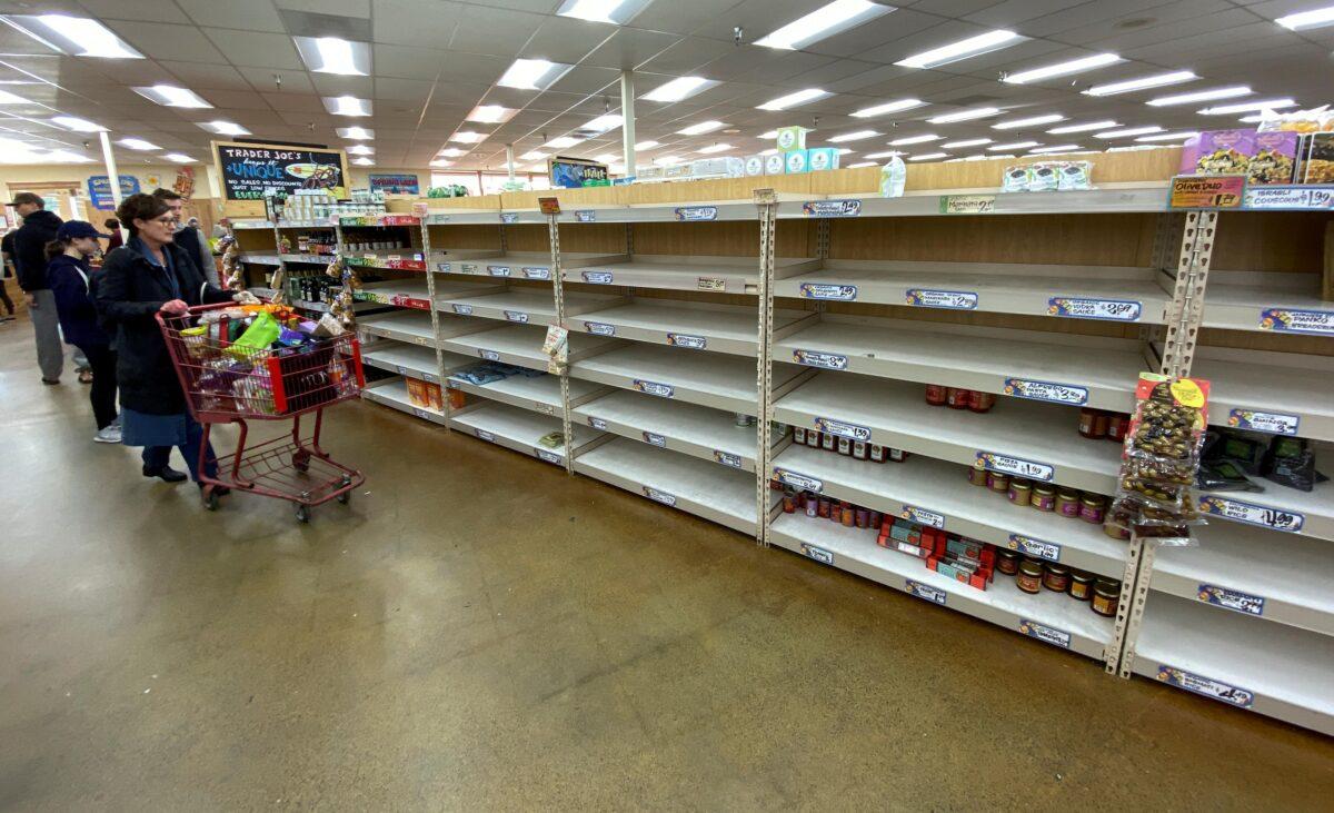 Shelves previously filled with pasta and canned food are seen empty at a Trader Joe's grocery store in Encinitas, Calif., on March 12, 2020. (Reuters/Mike Blake)