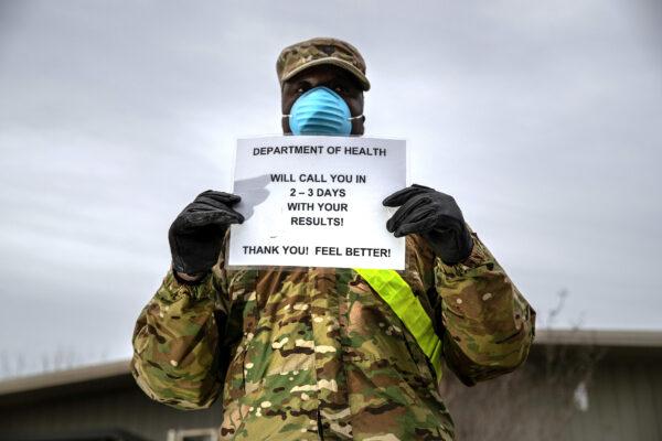 A U.S. National Guard soldier informs patients at a CCP virus testing center at Lehman College in the Bronx on March 28, 2020. (John Moore/Getty Images)