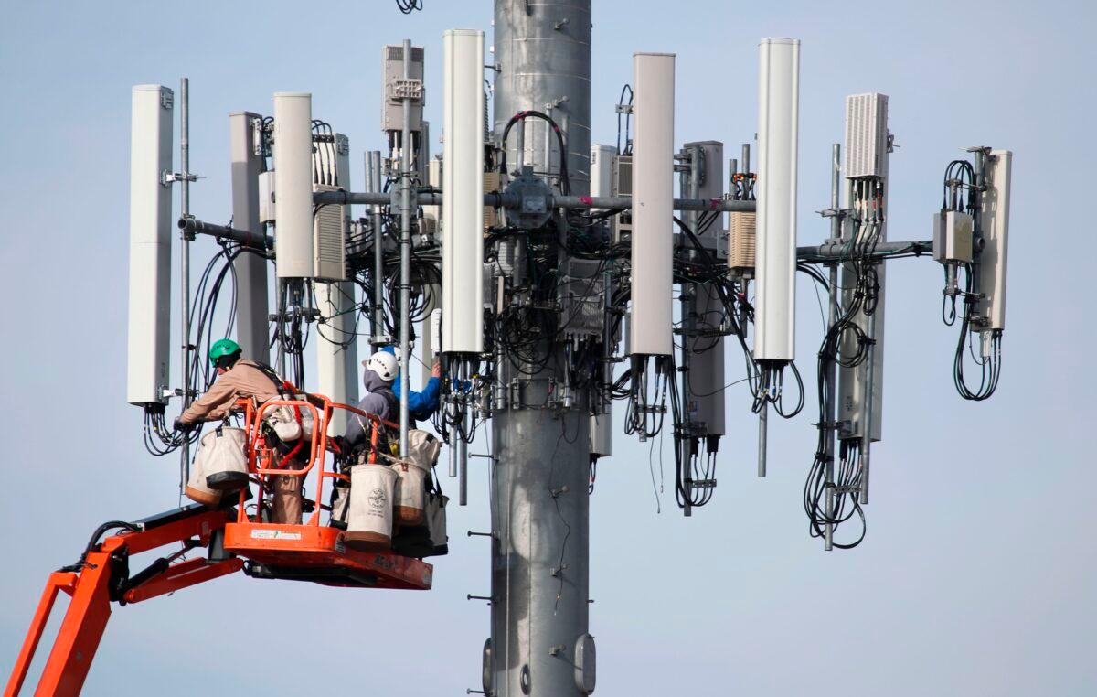 A crew works on a cell tower to update it to handle the new 5G network in Orem, Utah, on Dec. 10, 2019. (George Frey/AFP via Getty Images)