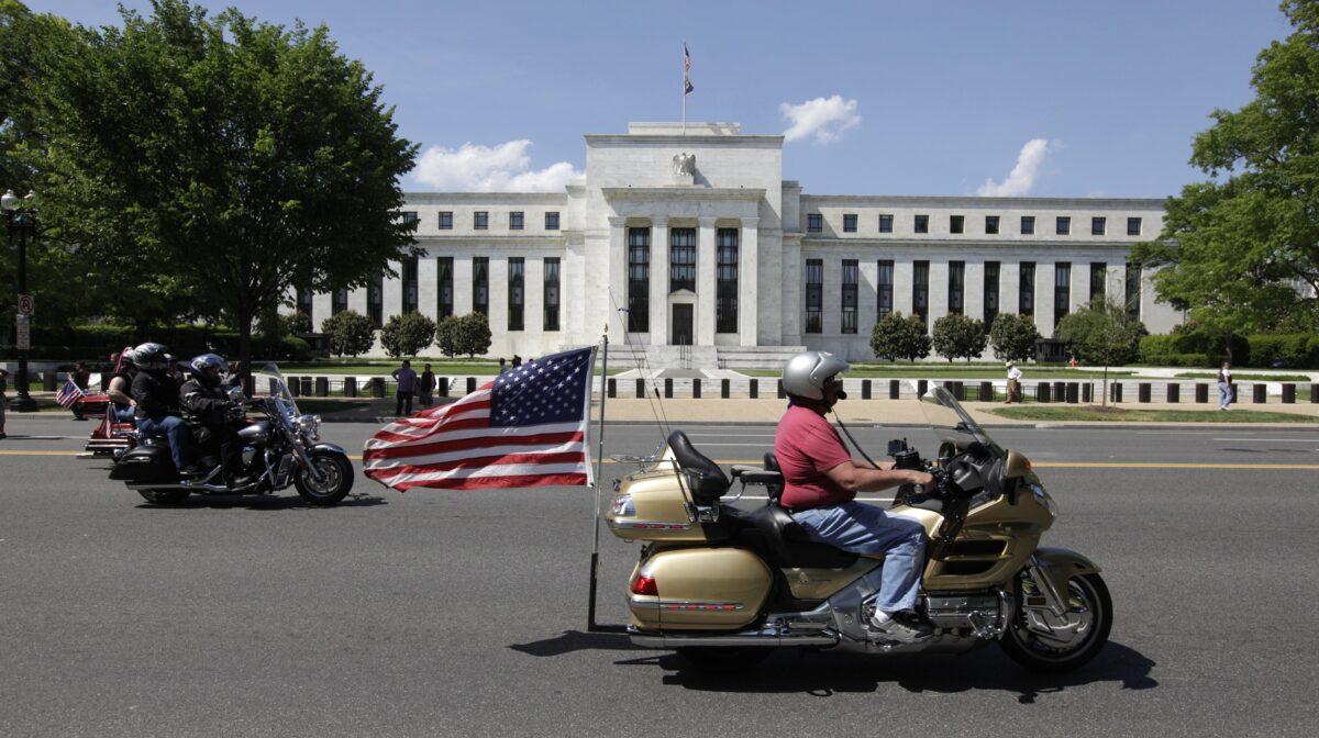 File photo of a motorcyclist riding by the Federal Reserve Building in Washington, DC, on May 24, 2015. (Chris Kleponis/AFP/Getty Images)
