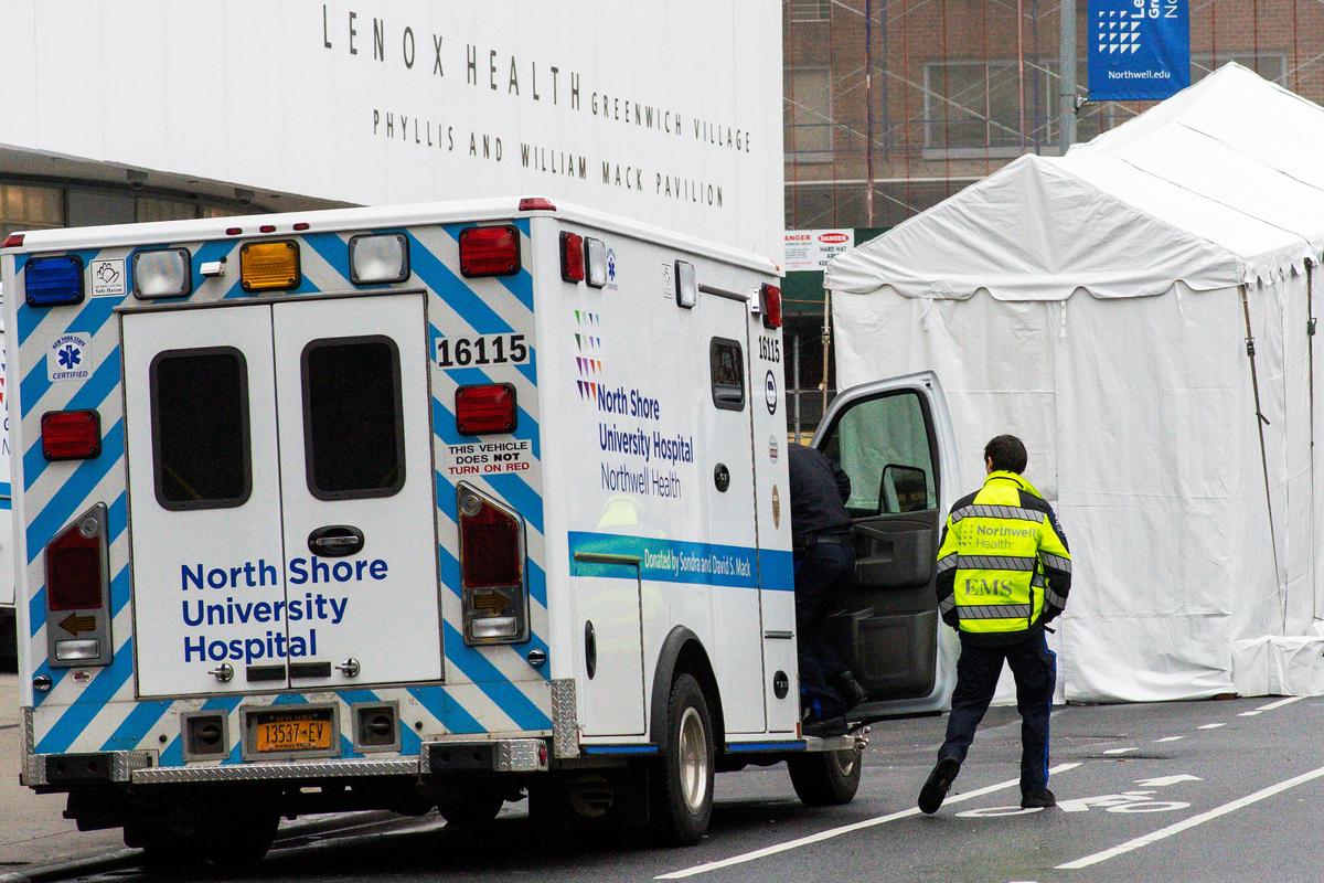 A paramedic walks next to a makeshift morgue set outside Lenox Health Medical Pavilion as the CCP virus outbreak continues in New York, on March 29, 2020. (Eduardo Munoz/Reuters)