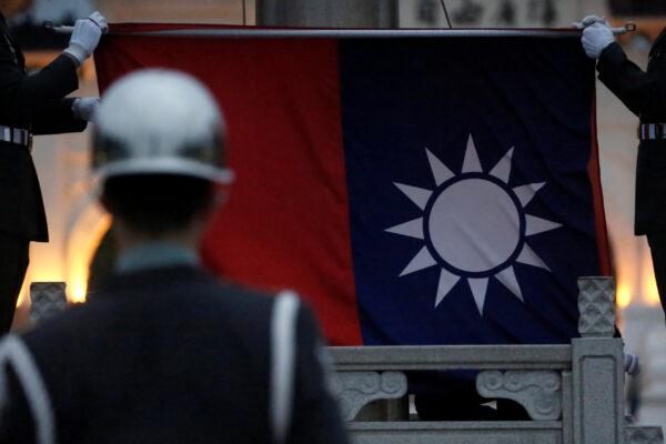 Honour guards perform Taiwan national flag lowering ceremony at Liberty Square, as the spread of the coronavirus disease (COVID-19) continues, in Taipei, Taiwan, on April 1, 2020. (Ann Wang/Reuters)