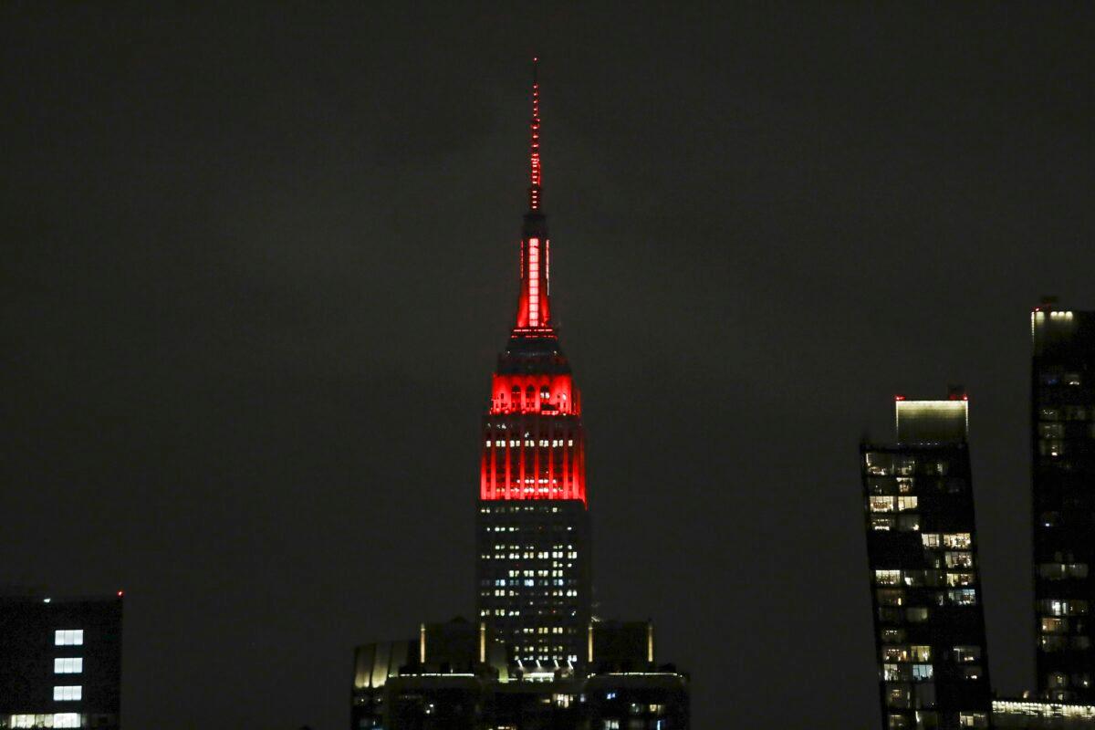 The Empire State building is lit in red and white lights to honor emergency medical workers in New York City on March 31, 2020. (Frank Franklin II/AP Photo)