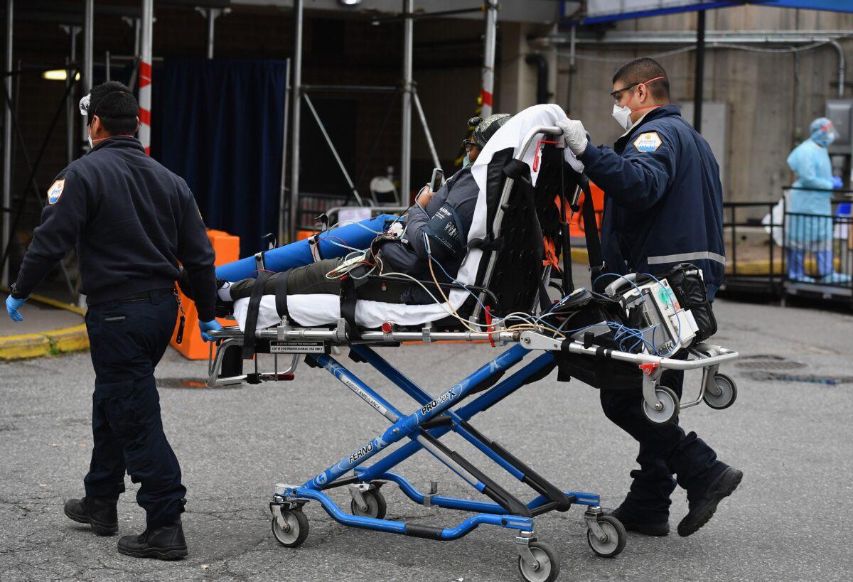 Paramedics push a gurney with a patient to Brooklyn Hospital Center Emergency Room in the Brooklyn borough of New York City on March 31, 2020. (Angela Weiss/AFP via Getty Images)