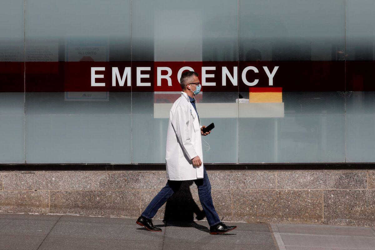 A doctor wears a protective mask as he walks outside Mount Sinai Hospital in Manhattan during the outbreak of the CCP virus in New York City on April 1, 2020. (Brendan Mcdermid/Reuters)