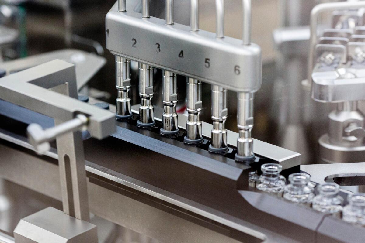 Rubber stoppers are placed onto filled vials of the investigational drug remdesivir at a Gilead manufacturing site in March 2020. (Gilead Sciences via AP)