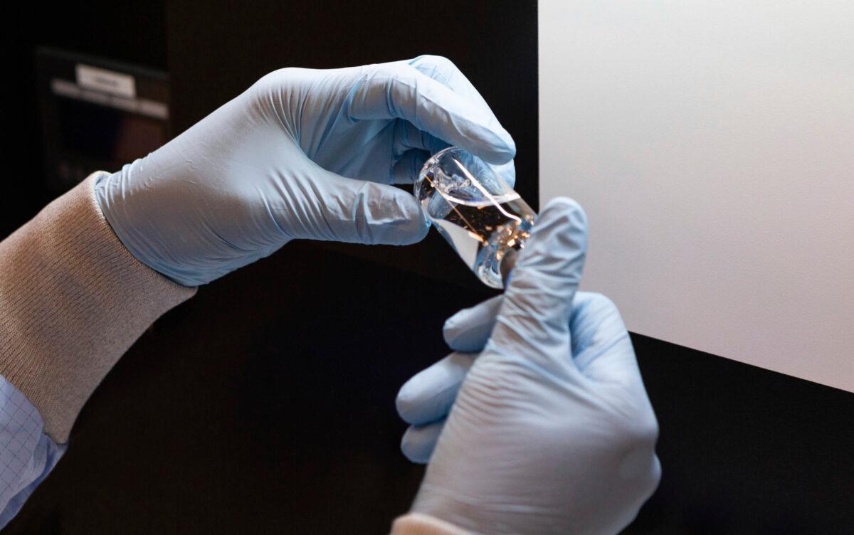 A vial of the investigational drug remdesivir is visually inspected at a Gilead manufacturing site in the United States, in March 2020. (Gilead Sciences via AP)