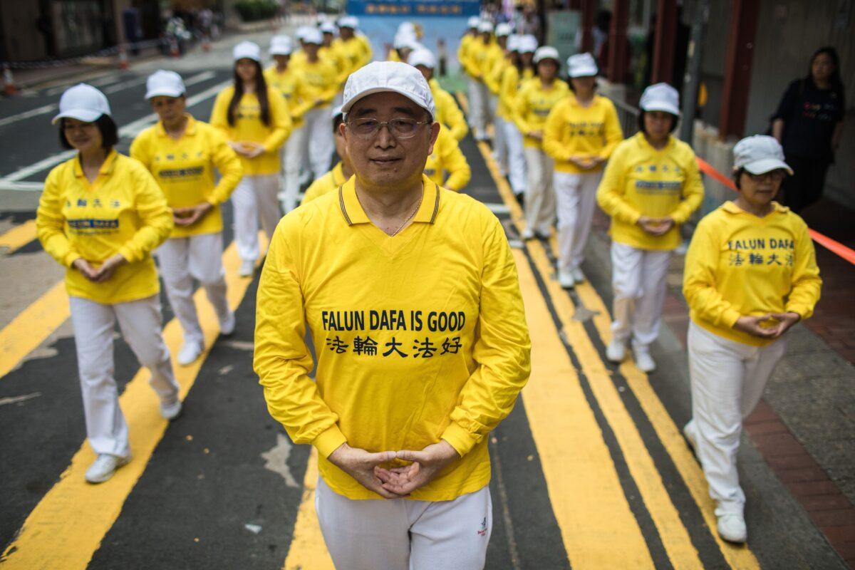 Supporters of the Falun Gong spiritual exercise take part in a march in Hong Kong on April 27, 2019. (Dale de la Rey/AFP via Getty Images)