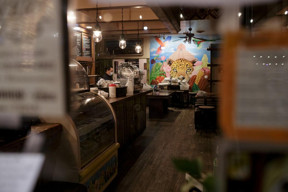 Ix, now closed for customers, is seen through the front windows as employee Daniel Gonzalez, 34, finishes cleaning and sanitizing the upstairs, in the Brooklyn borough of New York City, U.S., on April 2, 2020. (Anna Watts/Reuters)