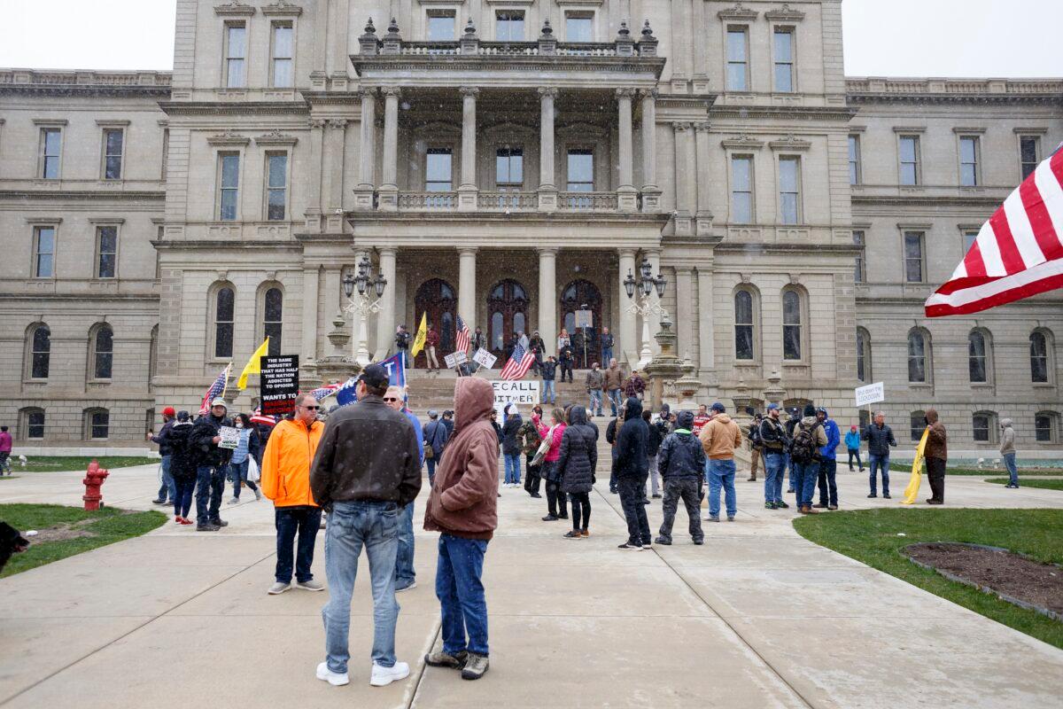 People gather on the Capitol's steps to express their unhappiness with Gov. Gretchen Whitmer's Stay Safe, Stay Home executive order in Lansing, Michigan, on April 15, 2020. (Elaine Cromie/Getty Images)