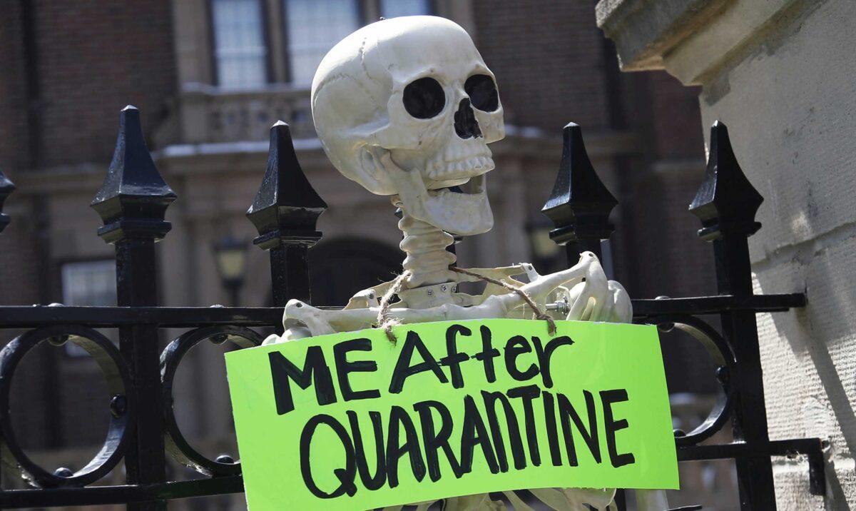 A mock skeleton is attached to the fence as protesters gathered outside Minnesota Gov. Tim Walz's official residence in St. Paul, Minn., on April 17, 2020, to call on him to loosen stay-at-home restrictions imposed across the state because of the coronavirus. (Jim Mone/AP Photo)