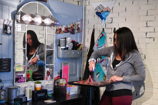 Brick House Salon co-owner Casey Aviles cleans up her station as she prepares to open for business later this week in Greeley, Colo., on April 28, 2020. (Michael Ciaglo/Getty Images)