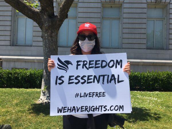 A protester at San Francisco City Hall on May 1, 2020, calling for the reopening of California. (Ilene Eng/The Epoch Times)