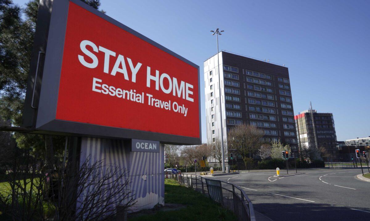 A giant television over the A57 Motorway urges people to stay home in Manchester, England, on March 26, 2020. (Christopher Furlong/Getty Images)