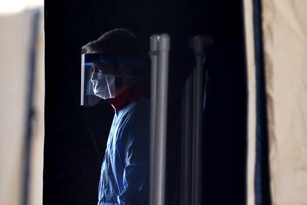 Health care professionals prepare to screen people for the coronavirus at a testing site erected by the Maryland National Guard in a parking lot at FedEx Field in Landover, Md., on March 30, 2020. (Chip Somodevilla/Getty Images)