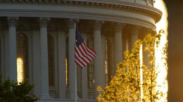 A U.S. flag flies in front of the Capitol building in Washington on May 13, 2020. (York Du/The Epoch Times)