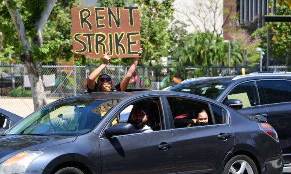 Demonstrators call for a rent strike during the COVID-19 pandemic as they pass City Hall in Los Angeles, on May 1, 2020. (Frederic J. Brown/AFP via Getty Images)