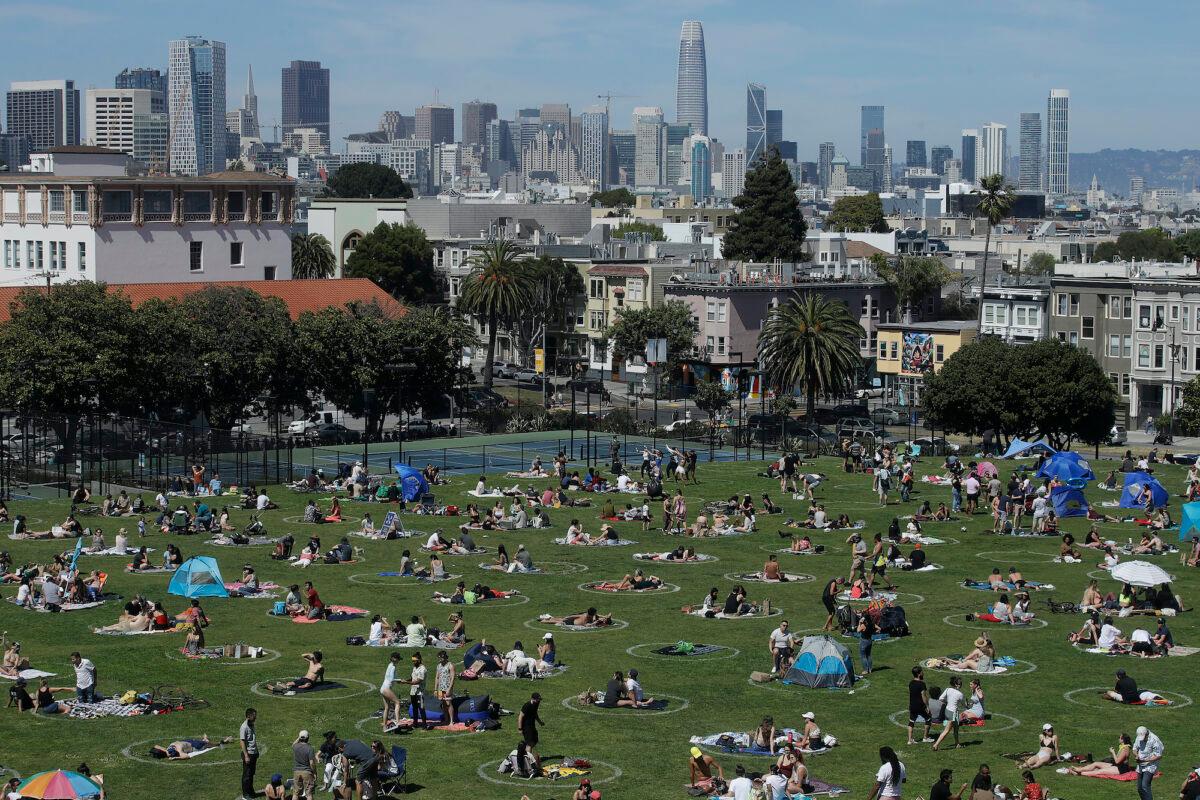 Visitors set up inside circles designed to help prevent the spread of the CCP virus by encouraging social distancing at Dolores Park in San Francisco, Sunday, May 24, 2020. (Jeff Chiu/AP photo)