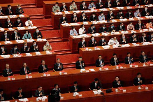 Chinese leader Xi Jinping and other officials applaud after the vote on the national security legislation for Hong Kong Special Administrative Region at the closing session of the National People's Congress (NPC) at the Great Hall of the People in Beijing, China, on May 28, 2020. (Carlos Garcia Rawlins/Reuters)