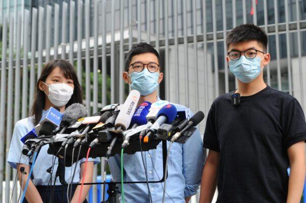 (L-R) Agnes Chow, Nathan Law, and Joshua Wong of local pro-democracy party Demosistō hold a press conference in Hong Kong on May 28, 2020. (Song Bilung/The Epoch Times)