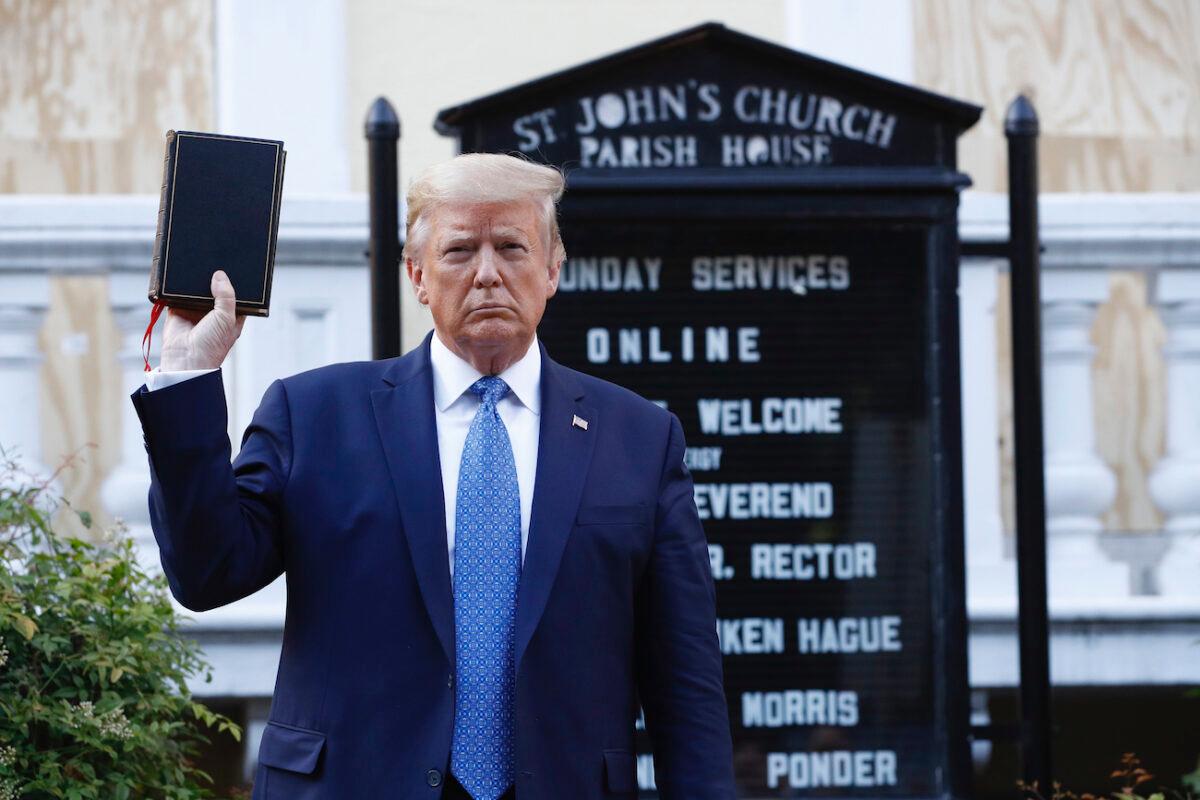 President Donald Trump holds a Bible as he visits outside St. John's Church across Lafayette Park from the White House, in Washington, on June 1, 2020. (AP Photo/Patrick Semansky)