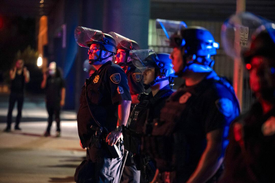 Man Charged After Hurling Brick Through Police Car Window During Riots: Police