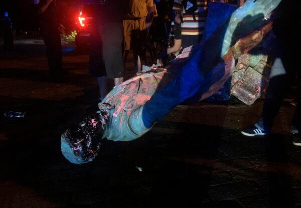 The statue of Confederate President Jefferson Davis is splattered with paint after it was toppled Wednesday night, along Monument Drive in Richmond, Va., on June 10, 2020. (Dylan Garner/Richmond Times-Dispatch/AP)