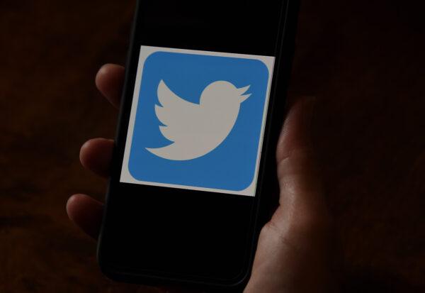 A Twitter logo is displayed on a mobile phone in Arlington, Va. on May 27, 2020. (Olivier Douliery/AFP/Getty Images)