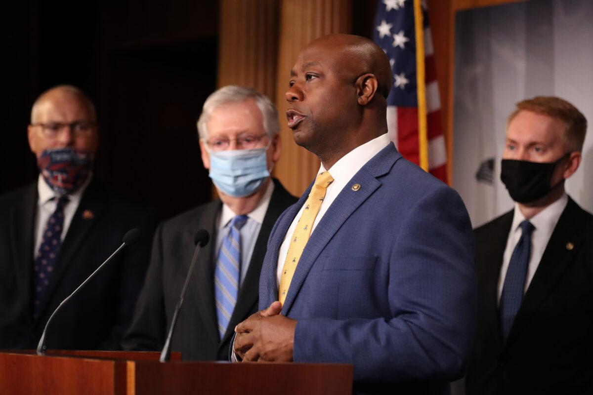 Sen. Tim Scott (R-S.C.), second from right, speaks with colleagues while introducing his police reform bill, in Washington on June 17, 2020. (Chip Somodevilla/Getty Images)