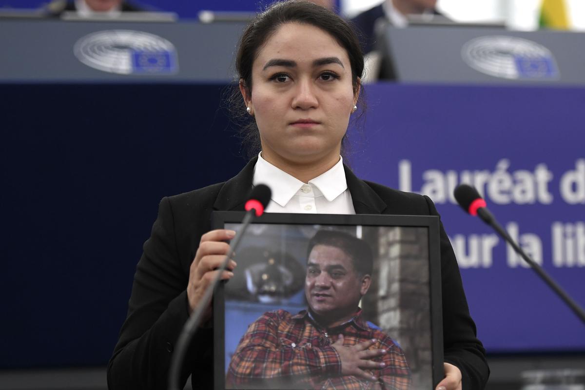Ms. Ilham, daughter of Mr. Ilham Tohti, holds a portrait of her father during the award ceremony for his 2019 European Parliament's Sakharov human rights prize at the European Parliament in Strasbourg, eastern France, on Dec. 18, 2019. (Frederick Florin/AFP via Getty Images)