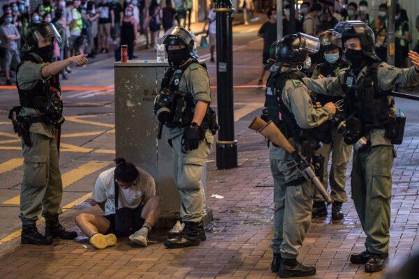 Riot police detain a man after they cleared protesters taking part in a rally against a new national security law in Hong Kong, on the 23rd anniversary of the city's handover from Britain to China, in Hong Kong, China, on July 1, 2020, (Dale De La Rey/AFP/Getty Images)