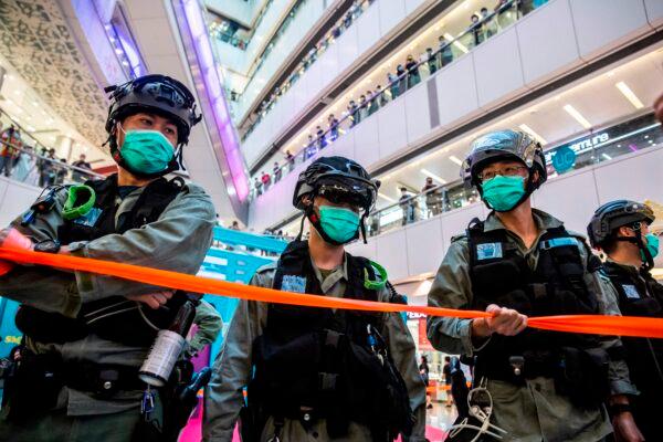 Riot police stand guard during a clearance operation during a demonstration in a mall in Hong Kong on July 6, 2020. (Isaac Lawrence/AFP via Getty Images)