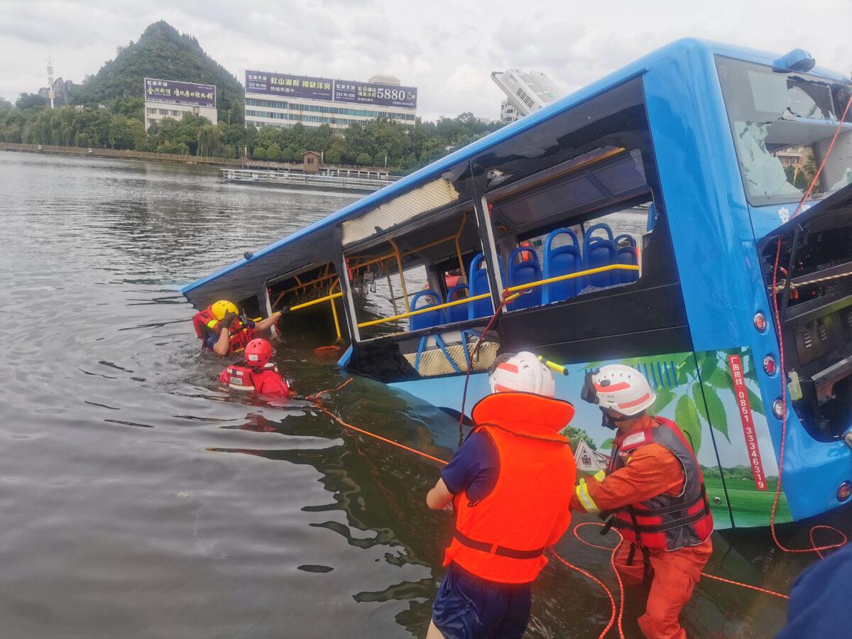 Rescue workers are seen at the site where a bus carrying students plunged into a reservoir, in Anshun, Guizhou province, China, on July 7, 2020. (China Daily via Reuters)