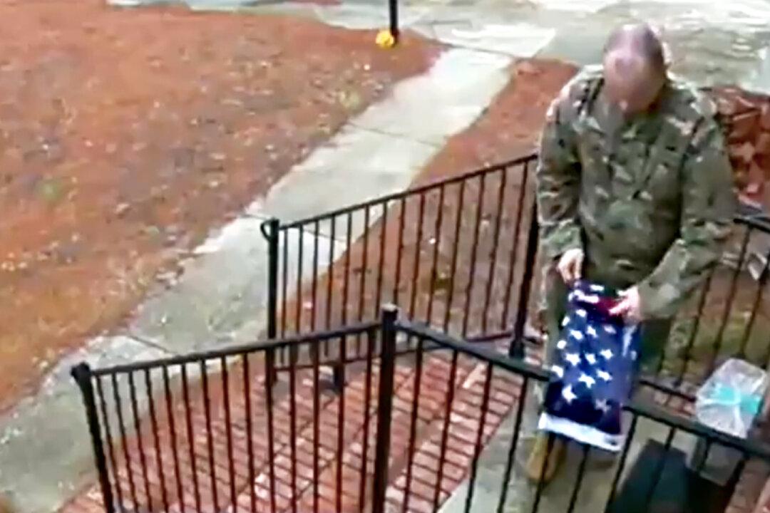 Touching Video Captures a Soldier Folding a Fallen American Flag Outside Stranger’s House