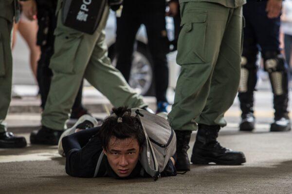 Riot police detain a man as they clear protesters taking part in a rally against a new national security law in Hong Kong on July 1, 2020. (Dale De La Rey/AFP via Getty Images)
