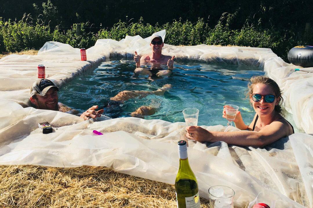 Family Build Makeshift Swimming Pool Out of Hay Bales in Backyard During Heatwave