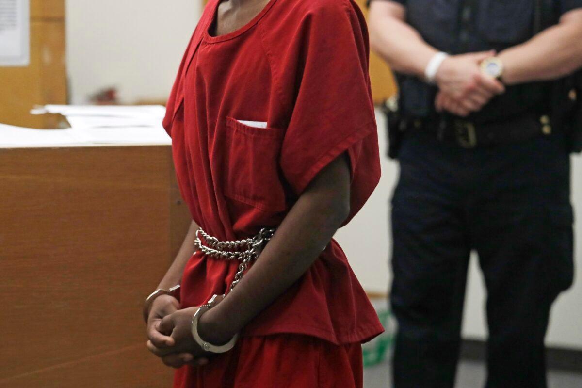 Dawit Kelete wears handcuffs chained to his waist as he walks into a court appearance in Seattle on July 6, 2020. (Elaine Thompson/AP Photo)